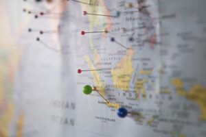 Push pins on a map representing planning to work remotely from another country